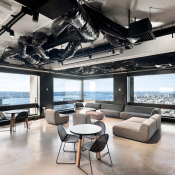 201 Elizabeth Street, Sydney, featuring a premium workplace lounge and collaboration hub with panoramic views across Hyde Park and Sydney Harbour, contemporary lounge furniture, café-style meeting settings, floor-to-ceiling glazing, and abundant natural light, creating an exceptional environment for informal meetings, workplace interaction, and employee wellbeing within Sydney CBD.